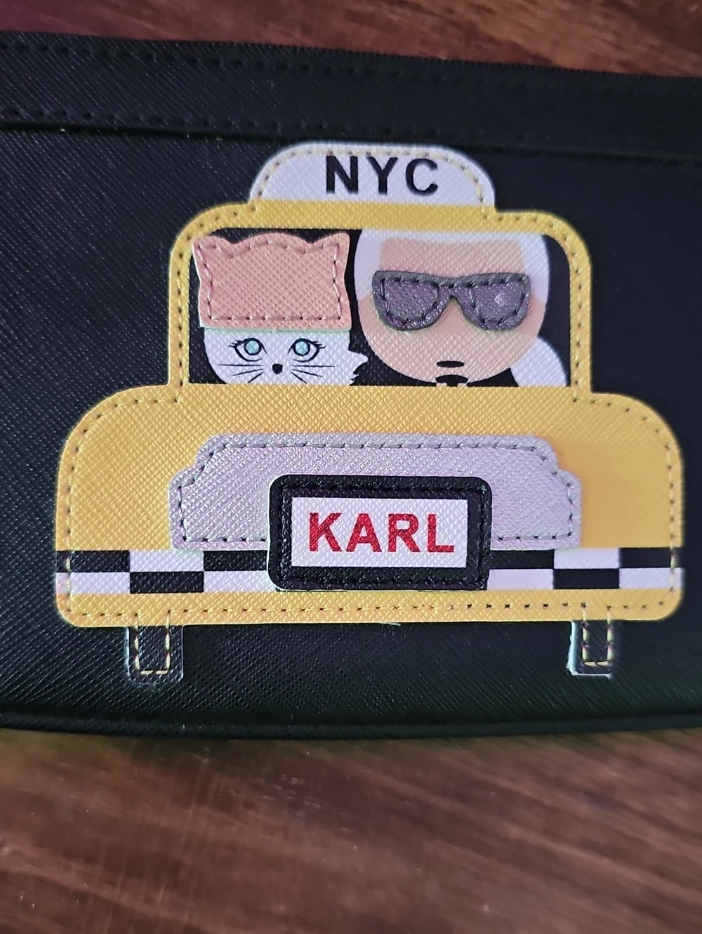 NWOT Karl Lagerfeld Black Wristlet with Yellow Taxi Appliqué